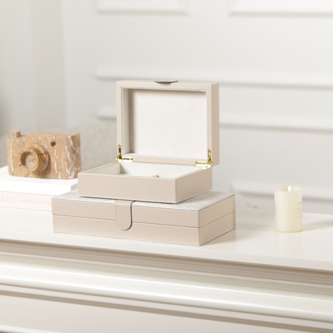 Decorative hinged leather jewelry box by BEACON with elegant stitching and a classic design, perfect for storing jewelry.