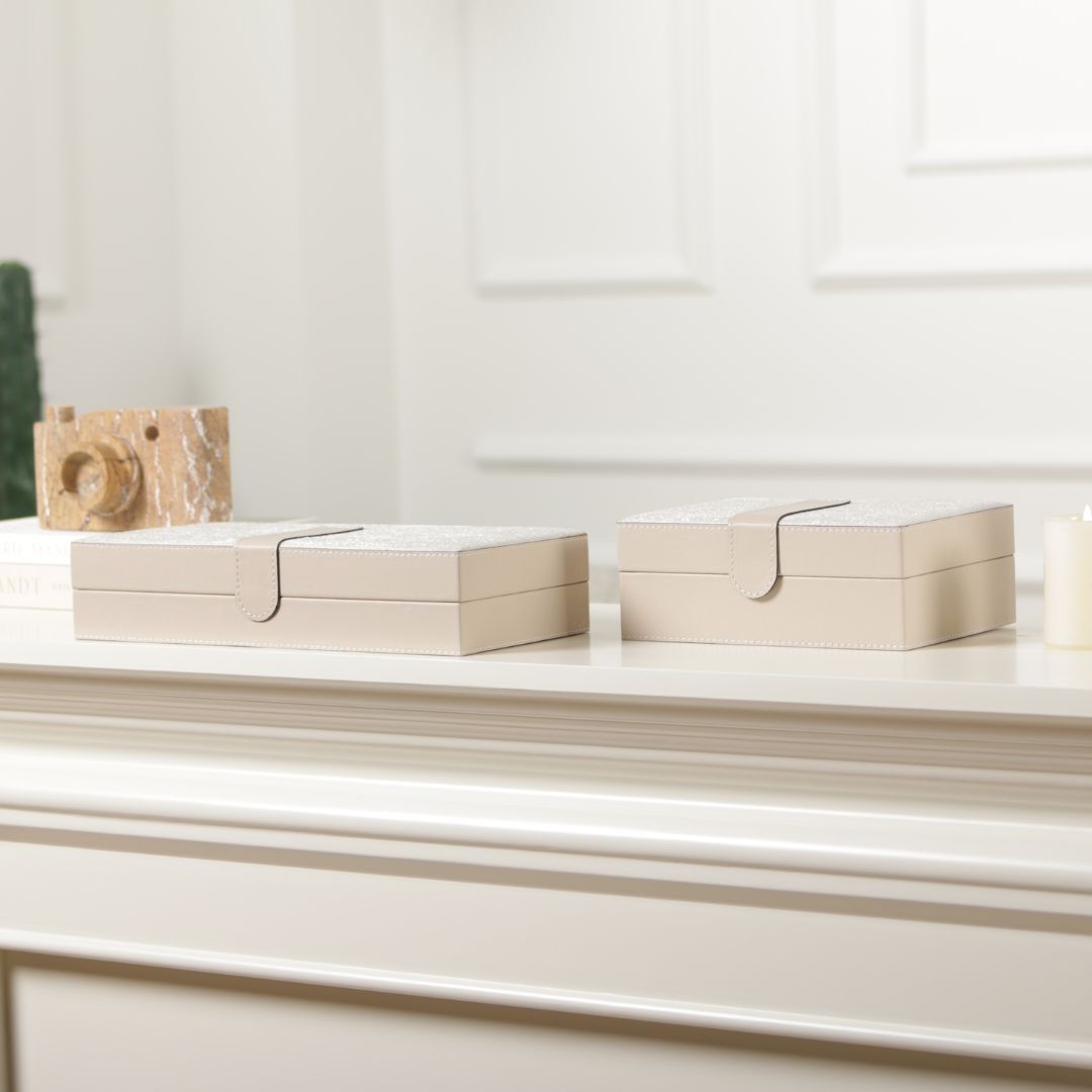 Hinged leather jewelry box by BEACON featuring a decorative design and compact storage for rings, necklaces, and small accessories.