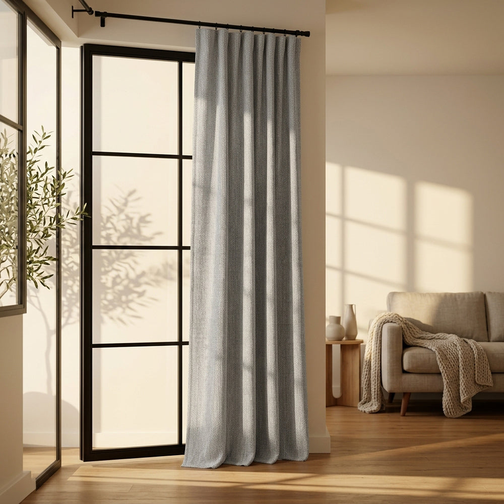 Close-up of BEACON Hush polyester curtain fabric, showing soft, textured blue drape with subtle pattern detail.