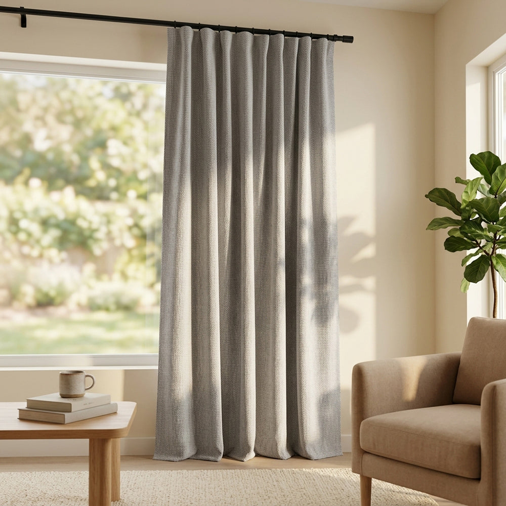 Beige Hush polyester curtain fabric by BEACON, showing smooth drape with subtle texture for curtains and window treatments.