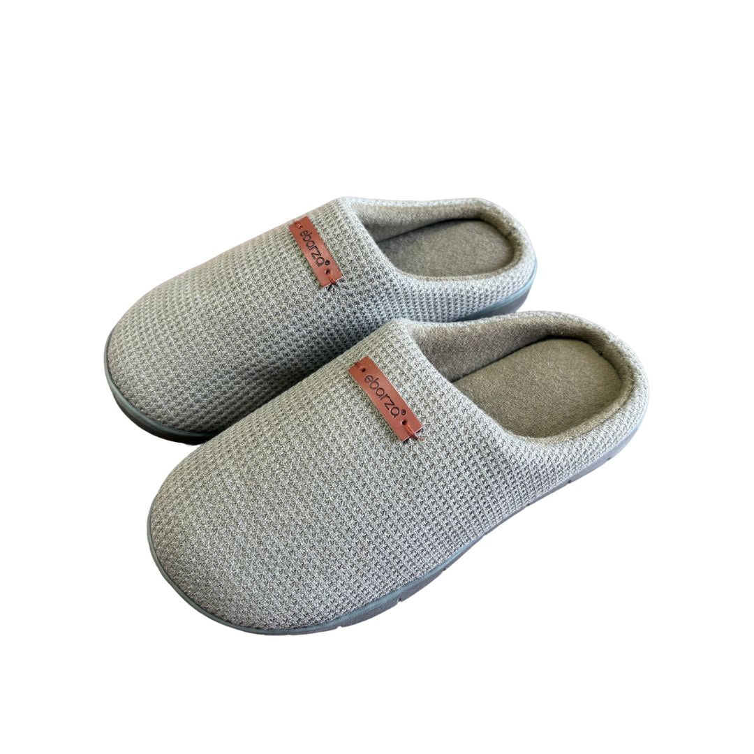 Light green women’s slippers by BEACON with soft fabric straps and cushioned soles, ideal for indoor comfort.