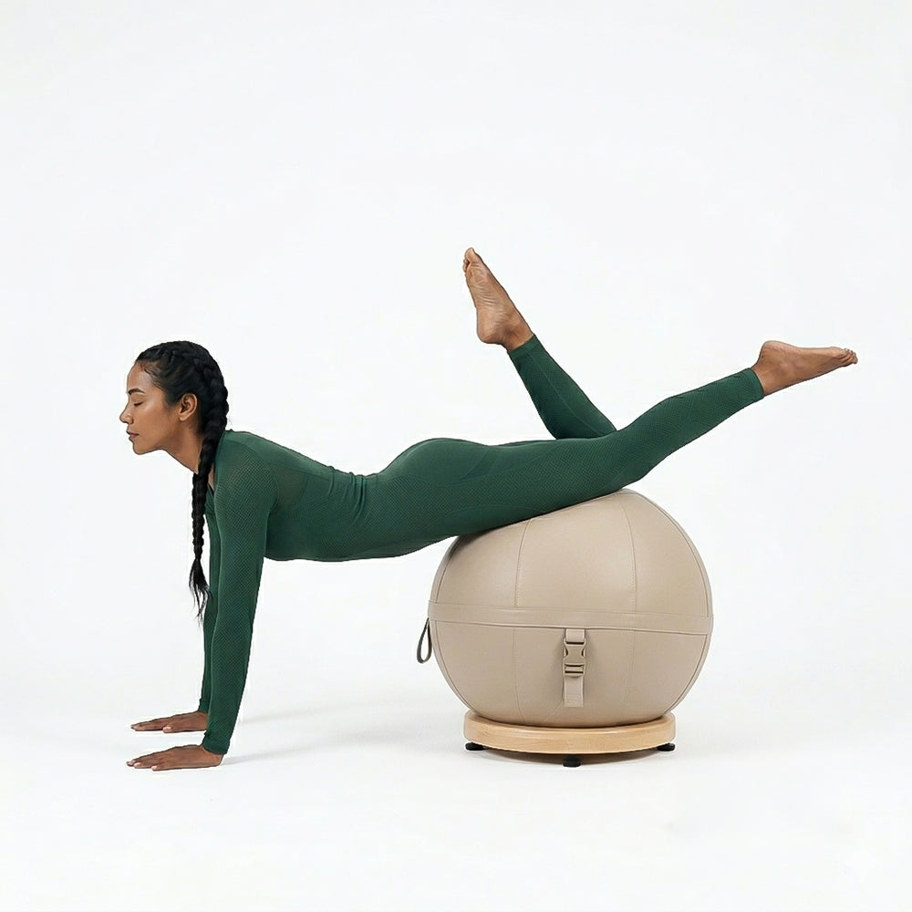 Leather yoga ball with beech wood base from BEACON, designed for fitness and balance exercises.