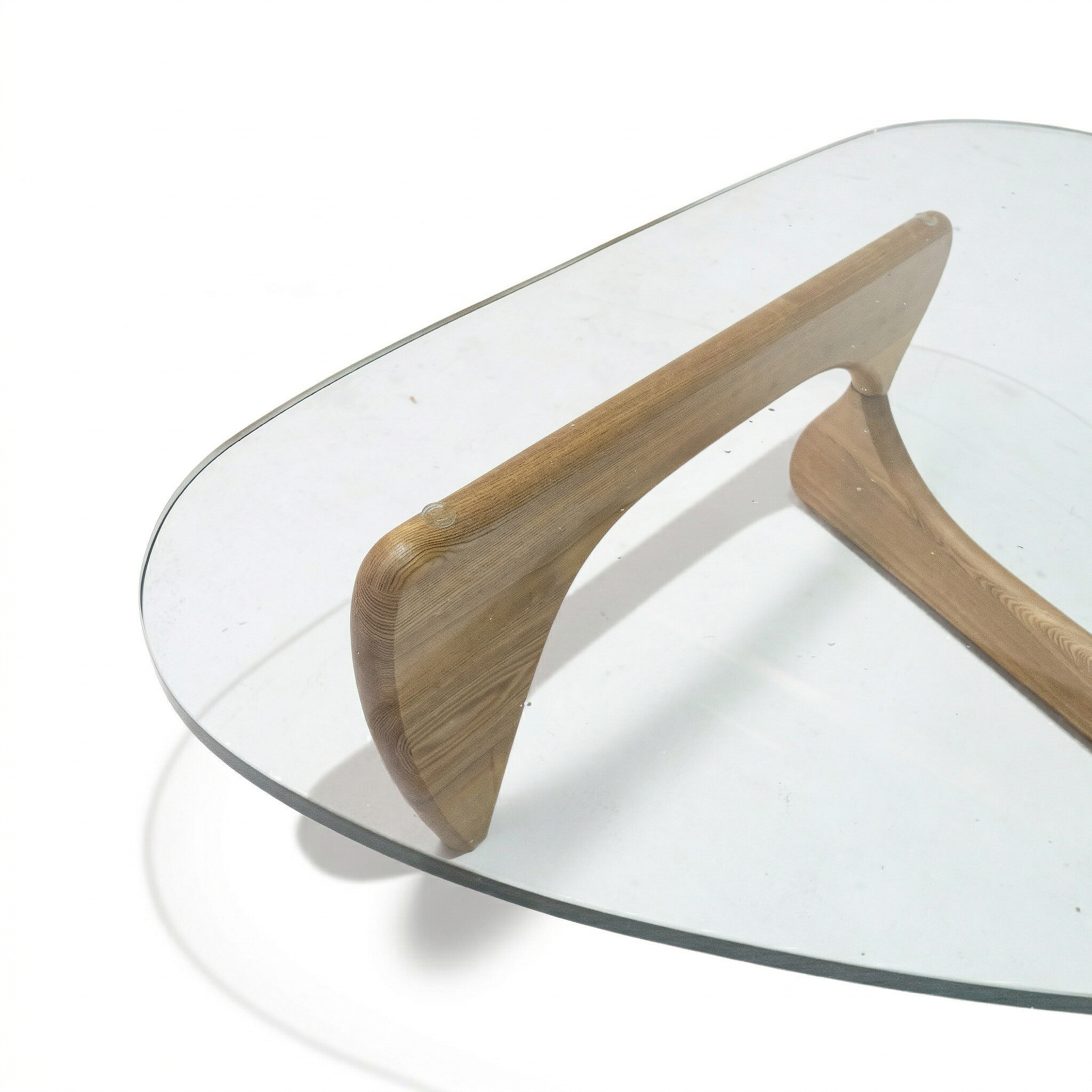 Light walnut Noguchi solid wood coffee table with glass top, modern design, and smooth rounded edges.