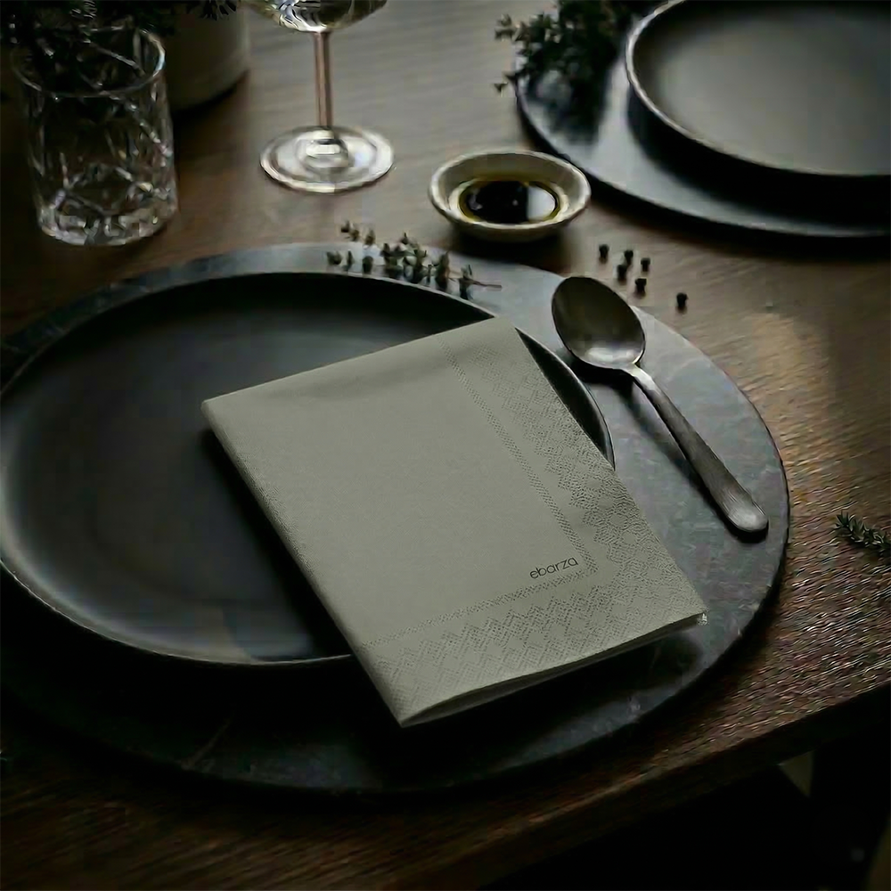 Printed paper napkin from DNFDG-22353 brand featuring colorful printed design, folded neatly for table setting.