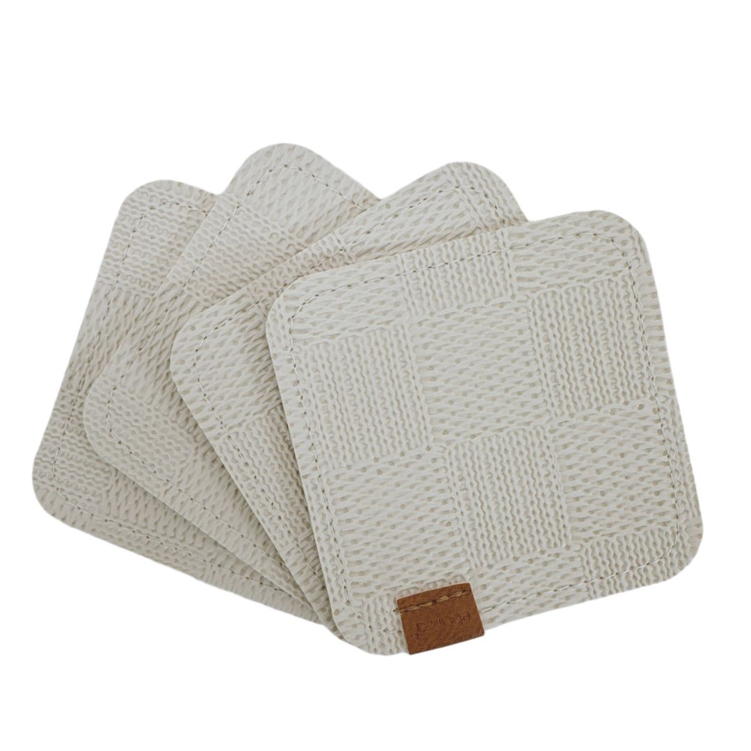 Set of four beige BEACON coasters with a smooth surface, perfect for protecting tables from drink rings.