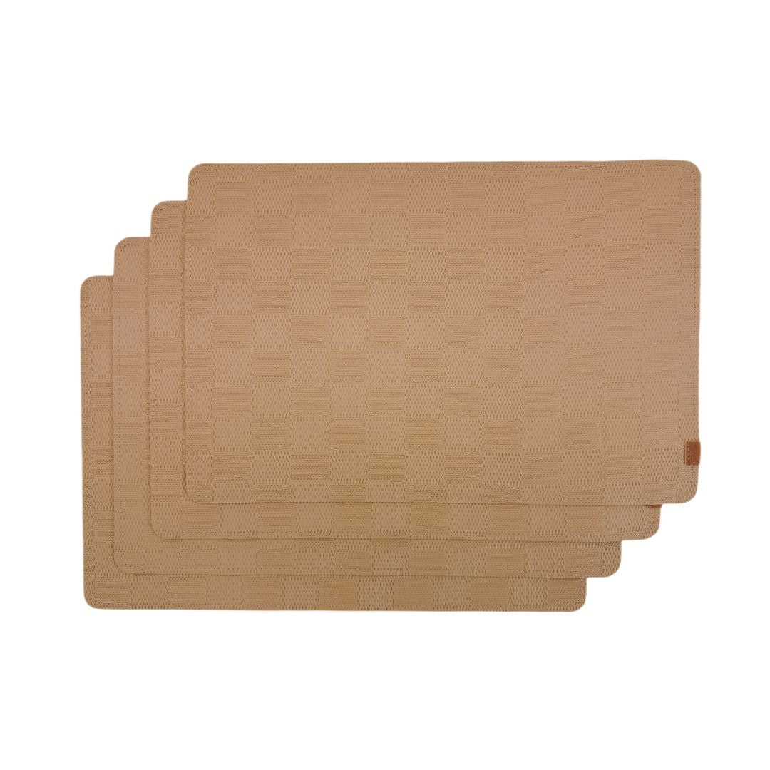 Set of 4 taupe placemats from BEACON, arranged with basket packaging, showcasing durable fabric and elegant design.