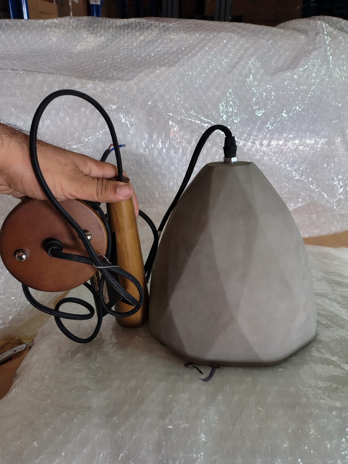 Large convex concrete and wood lamp by Beacon, featuring a modern design with a curved glass shade and wooden base.