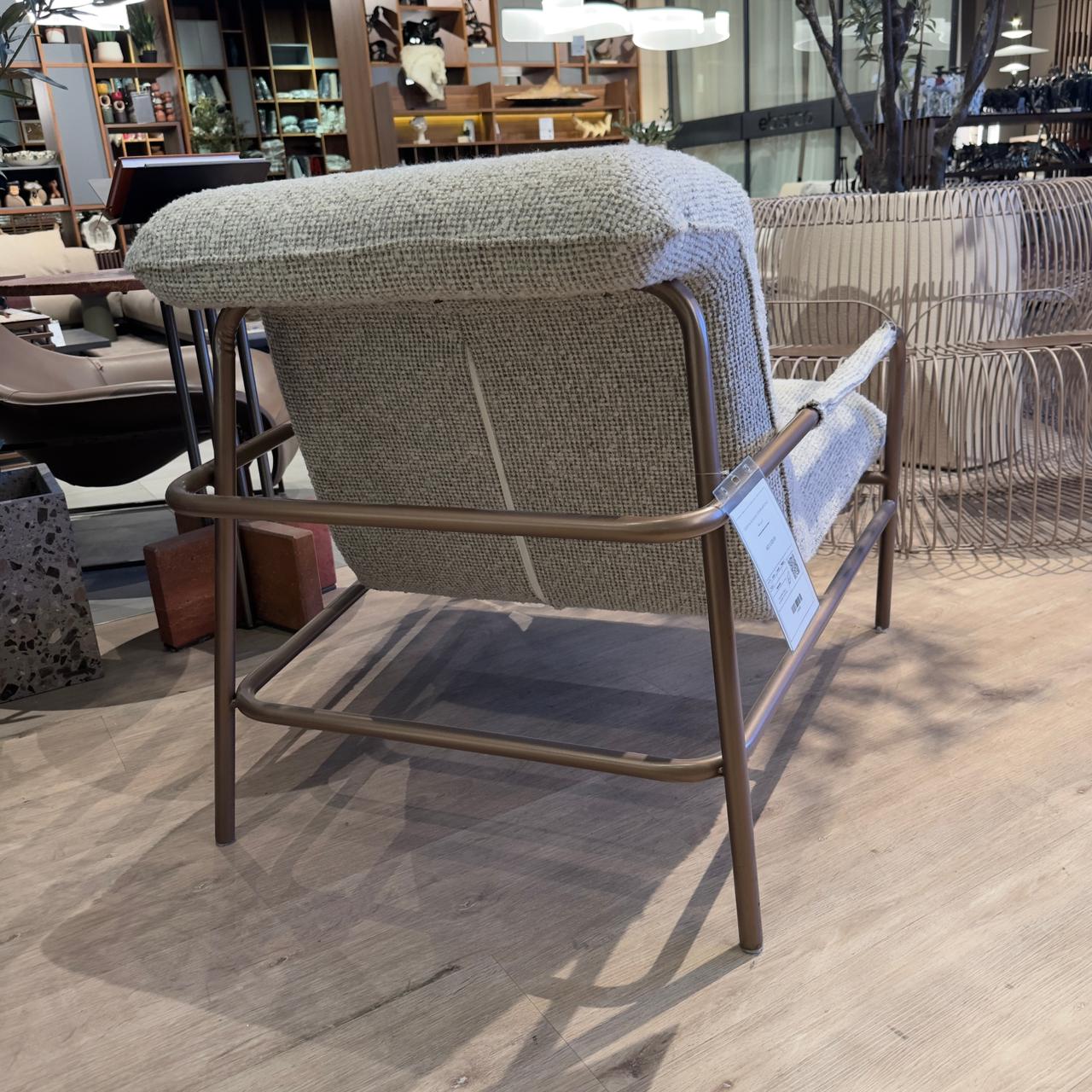 HOMAGE KOLTUK Gamma Armchair display item with modern design, upholstered in fabric, showcasing its sleek shape and comfortable seating.