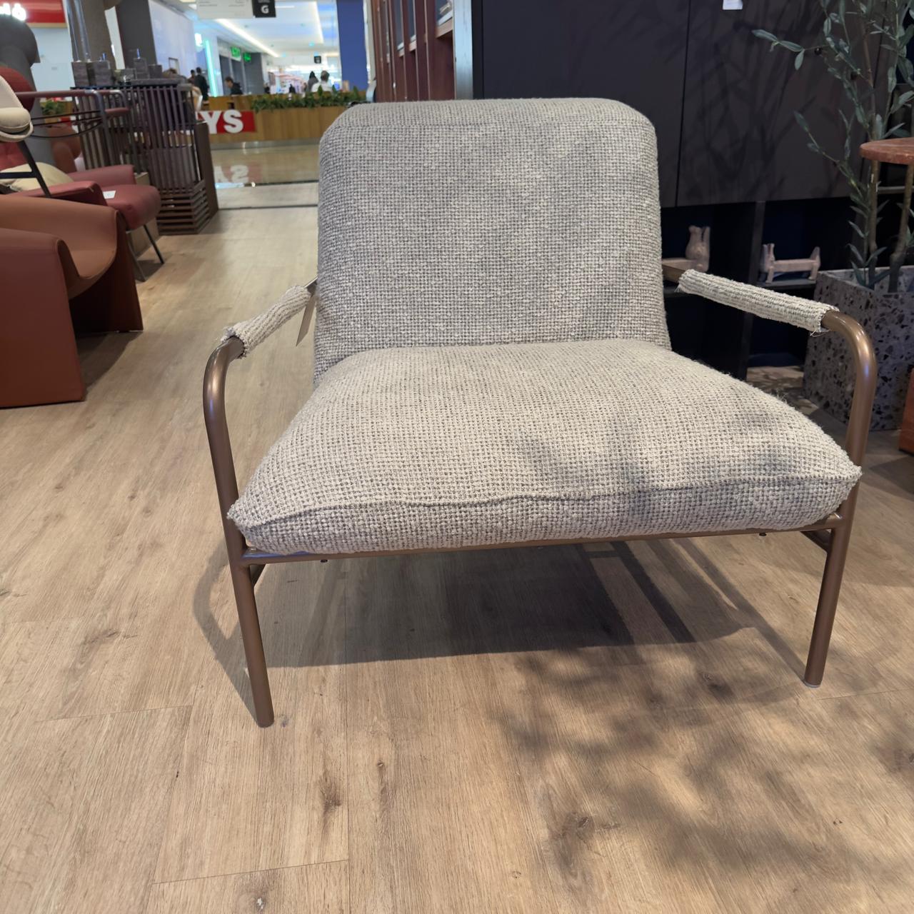 Gamma armchair by Homage Koltuk, showcasing modern design with plush upholstery and sleek wooden legs.