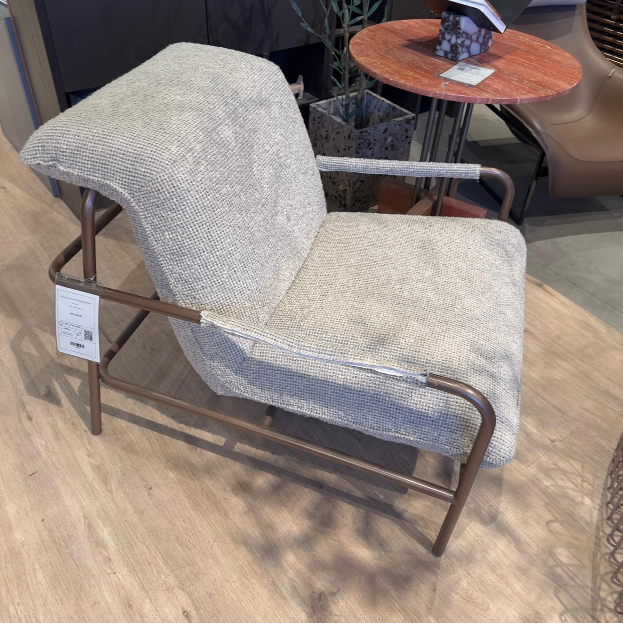 Modern Gamma Armchair by HOMAGE KOLTUK, showcasing a sleek design and plush upholstery in a stylish display setting.
