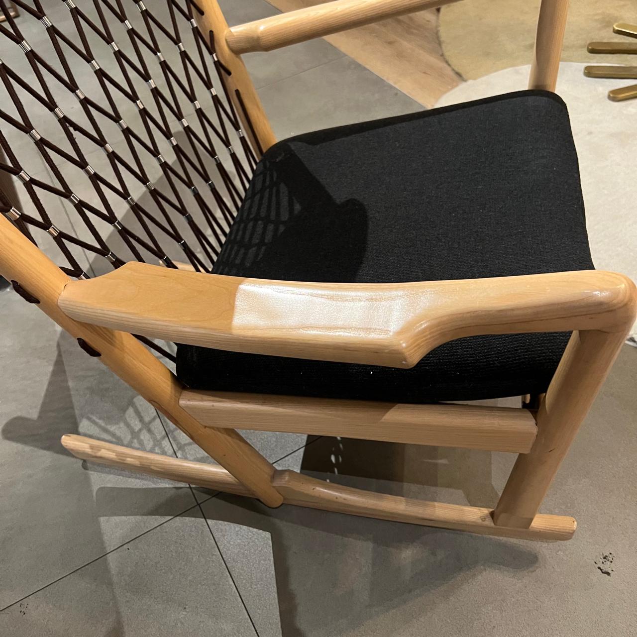 Solid wood and cord lounge chair display item by RUDI, featuring a modern design with a comfortable cushioned seat and natural wood finish.