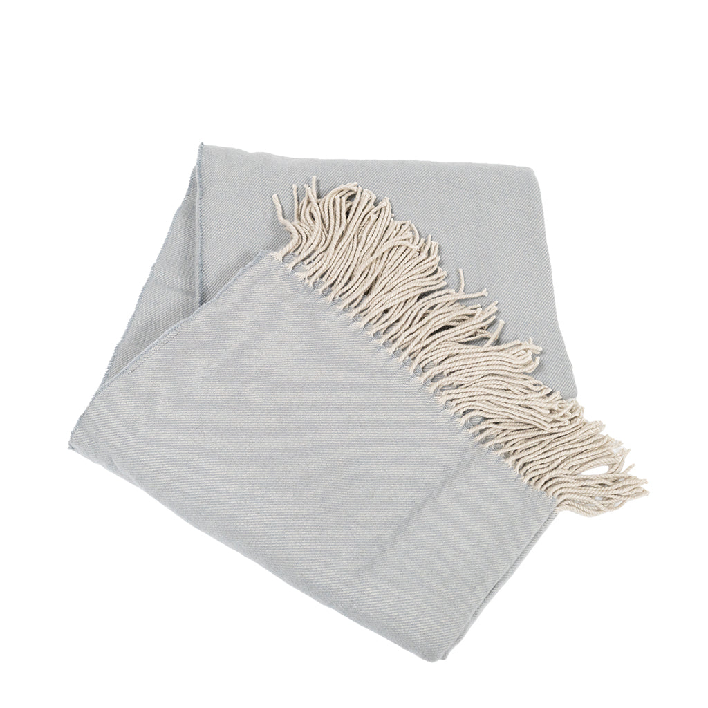 BEACON Fjord Wool Throw Blanket DR-THW15 displayed folded on a cozy sofa, showcasing soft, textured wool fabric.