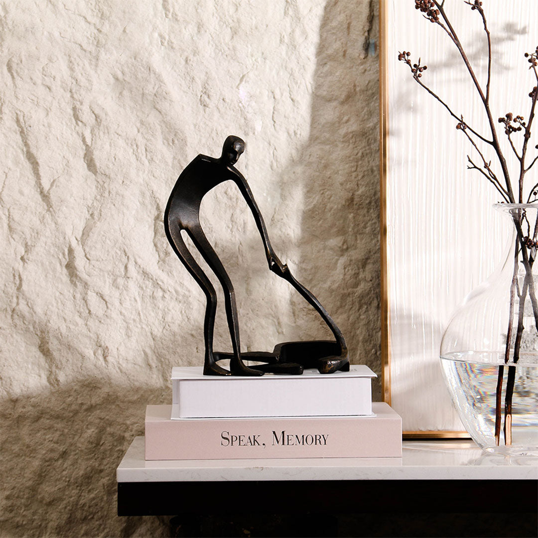 Abstract metal sculpture from BEACON, modern home decor figurine with sleek, artistic design in polished metal finish.