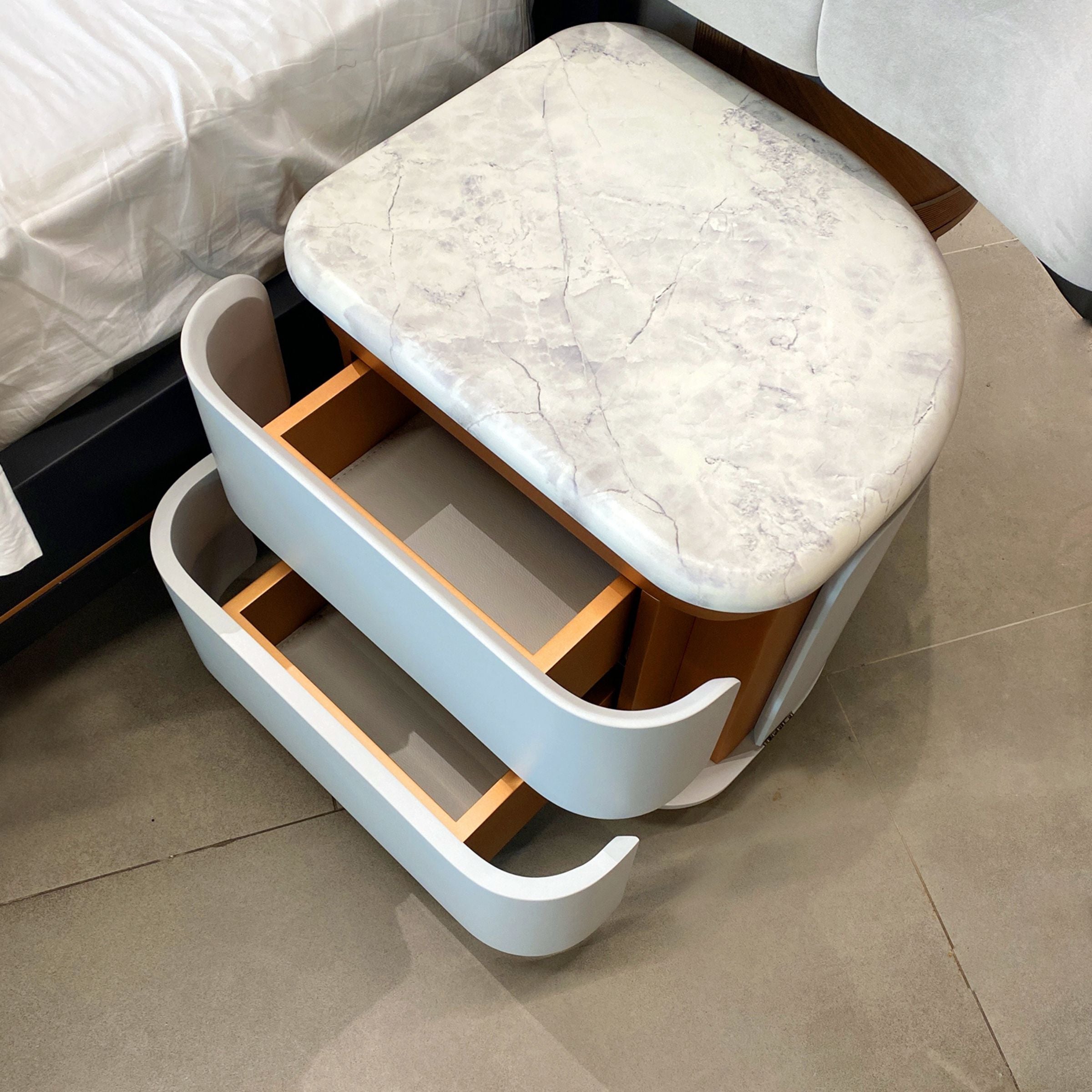 Two tulip-shaped bedside tables by LODA Furniture in display condition, showcasing their unique design and natural wood finish.