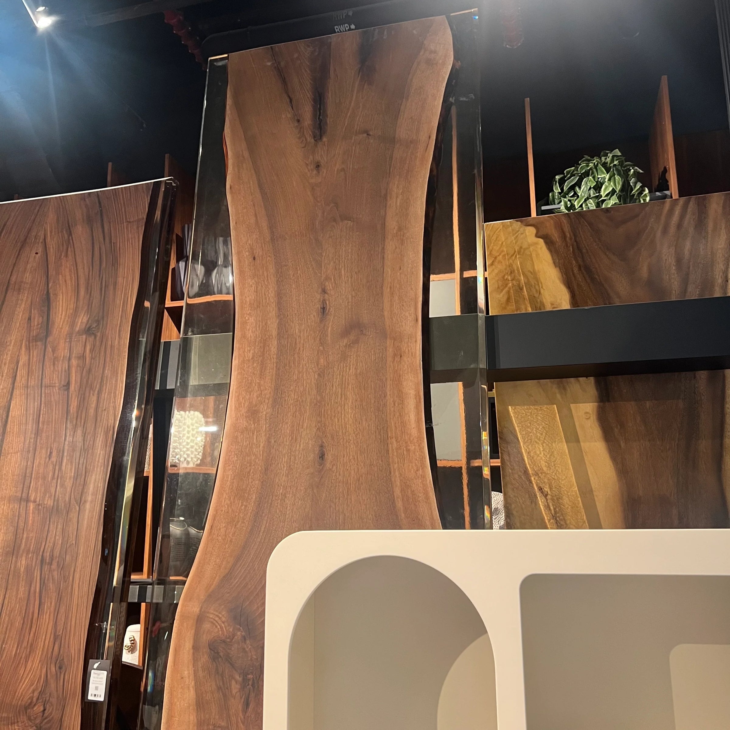 Live edge resin dining table top in natural wood finish, 350x100 cm, by SANCREA, displayed as a showroom sample.