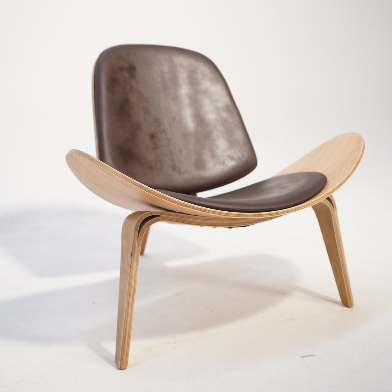 As-is Smile Lounge Chair by BEACON, display item showing a modern, cushioned lounge chair with wooden legs and a contemporary design.