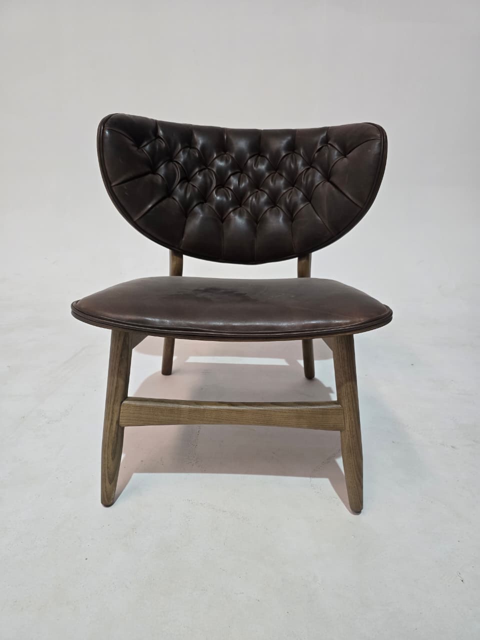 Vintage brown Flora Lounge Chair by OZZO, displayed as-is with a pull-up leather design, showcasing its stylish, worn look.