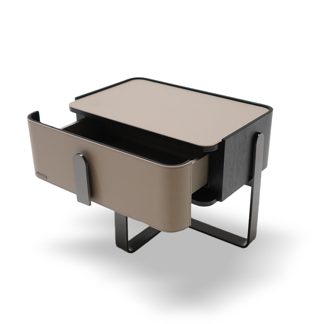 Saddle leather bedside table by BEACON with a sleek design, featuring a smooth leather surface and compact storage space.