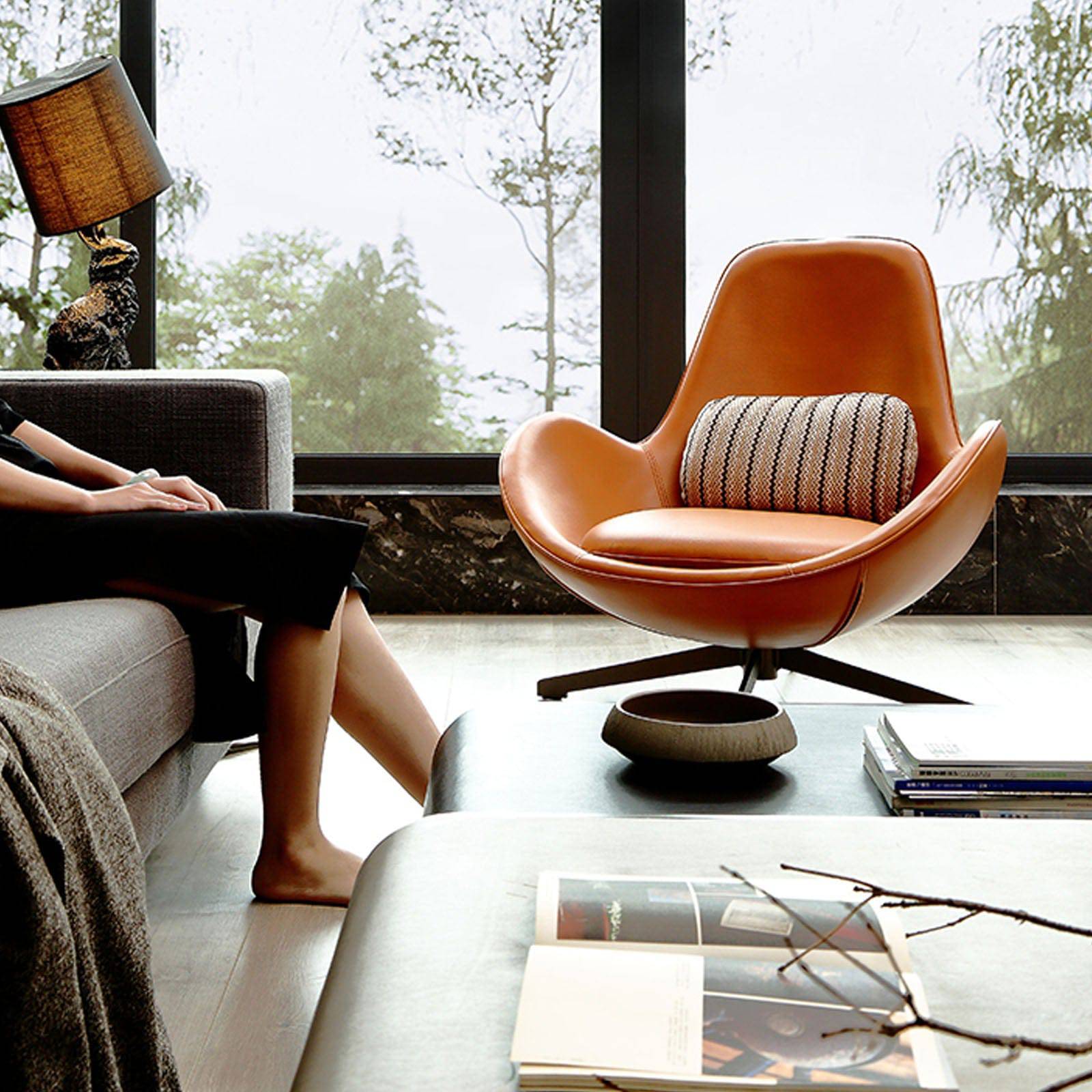 As-is Vigo swivel lounge chair by Beacon, display model with modern design, upholstered seat and backrest, metal base.