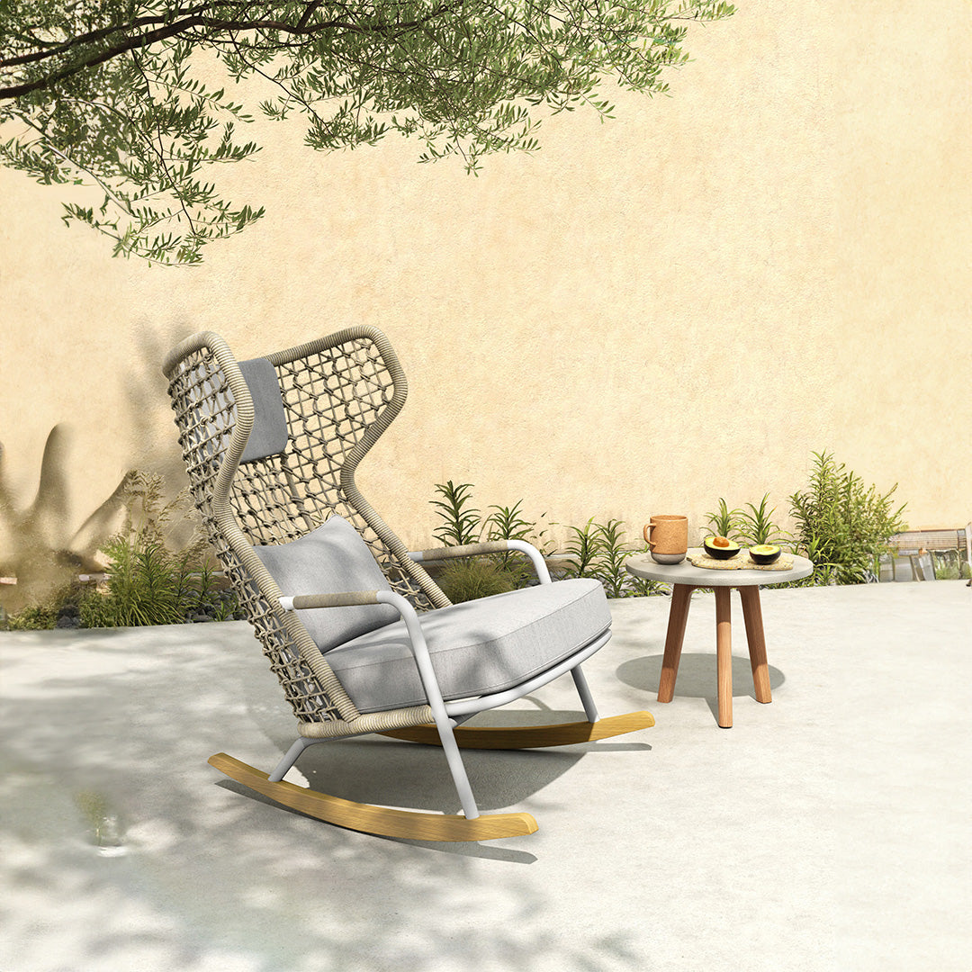 BEACON Banyan indoor/outdoor rocking armchair with wooden frame and cushioned seat for comfortable relaxation.
