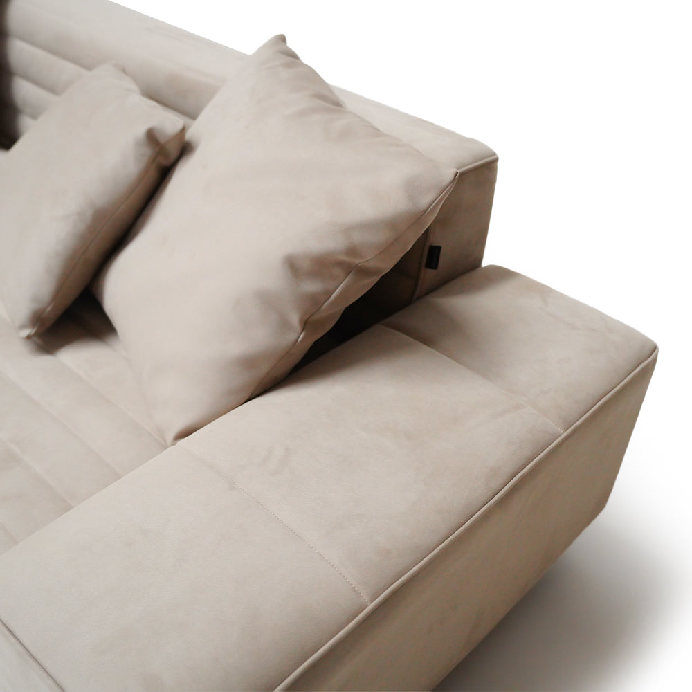White Baxter corner sofa set by BEACON, featuring plush cushions and modern design, shown from a side angle.
