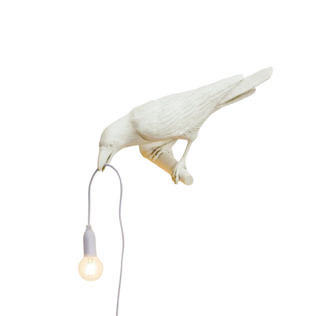 Beige bird-shaped wall lamp by BEACON, mounted on a wall, with detailed bird design and soft lighting for interior decor.