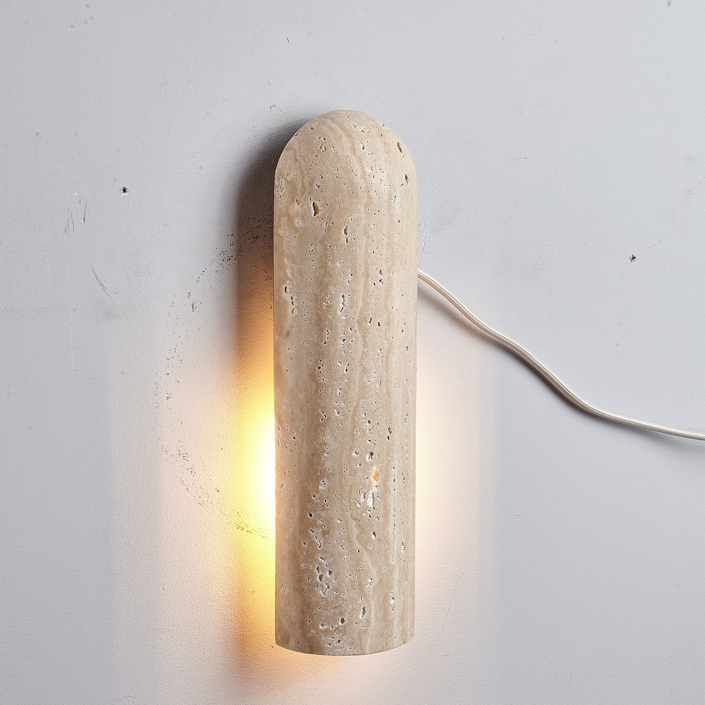 Beige natural travertine marble wall lamp by BEACON, featuring a sleek design and warm lighting for interior decor.