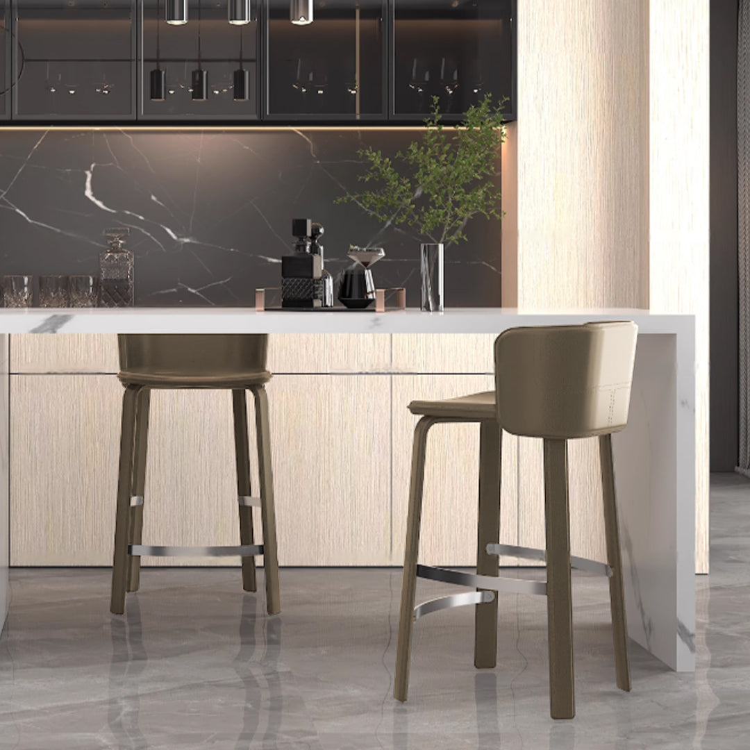 Beige saddle leather bar stool from BEACON with a sturdy metal frame, featuring a comfortable cushioned seat and backrest.