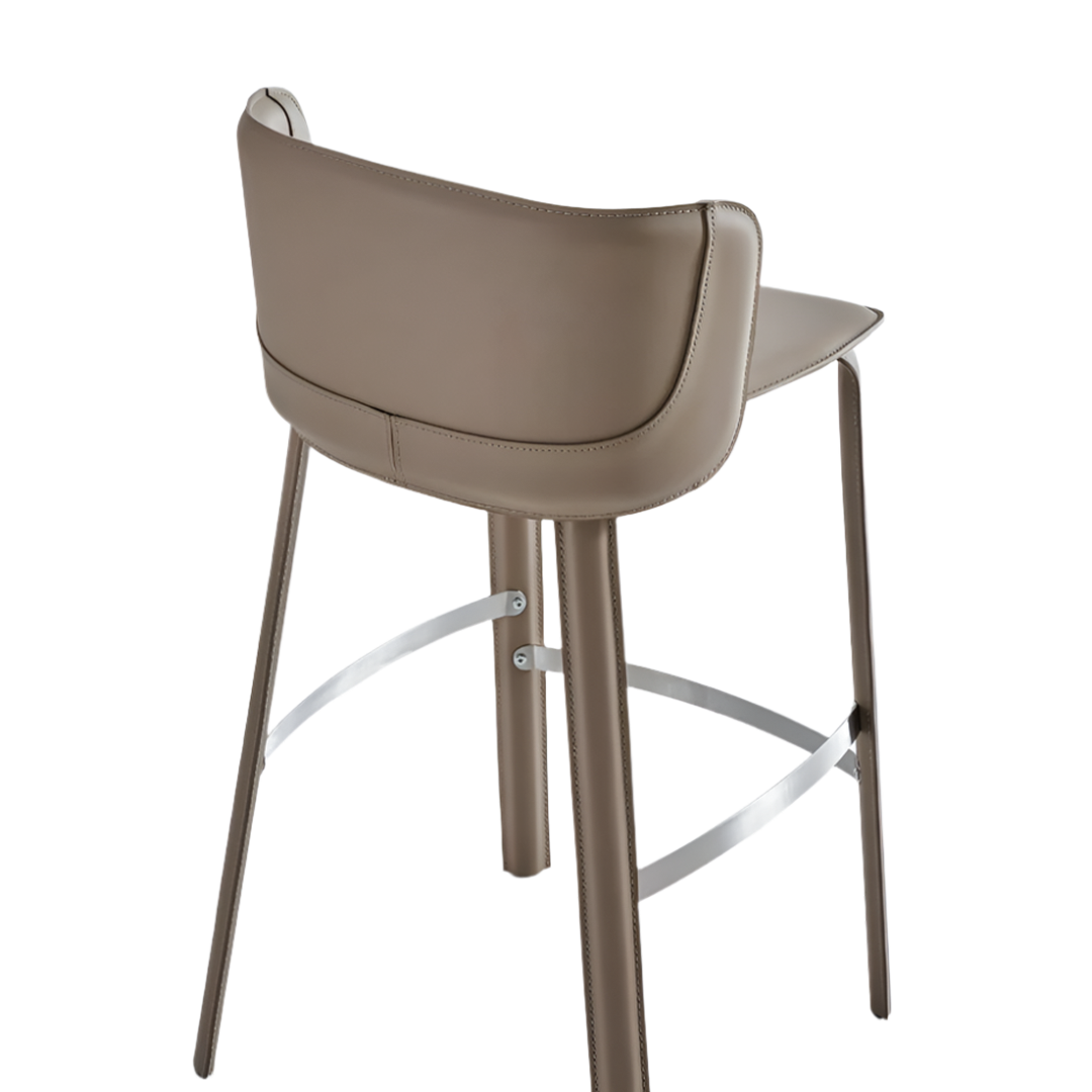 Beige saddle leather bar stool by BEACON with metal legs, featuring a classic design and comfortable cushioned seat.