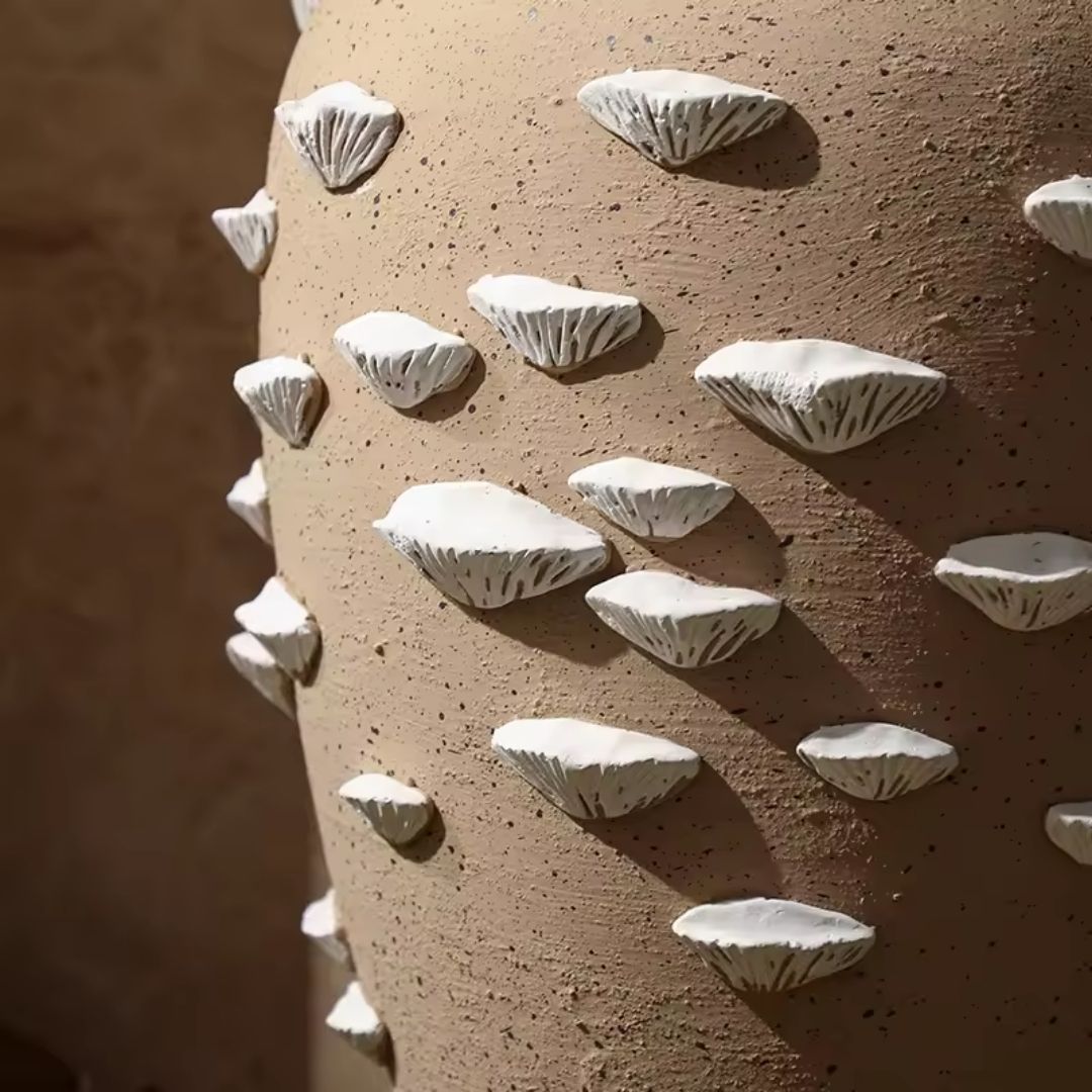 Beige and white cement vase with shell detail from BEACON, featuring a sculpted shell design on a stylish vase.