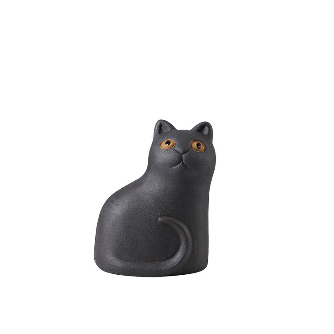Big-eyed cat figurine from BEACON home decor collection, detailed ceramic cat sculpture with expressive eyes.