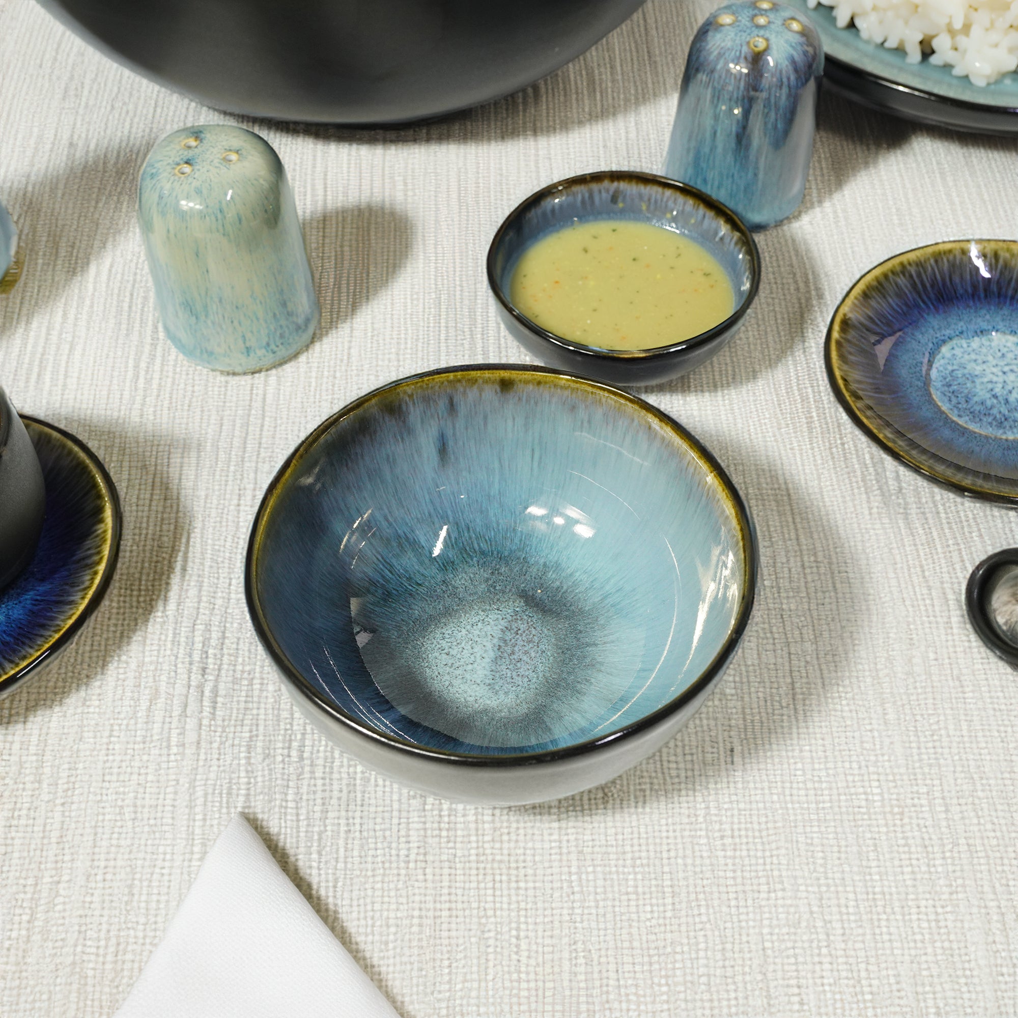 Black and blue wave-patterned bowl from Beacon, featuring a sleek design and vibrant color contrast, perfect for serving.
