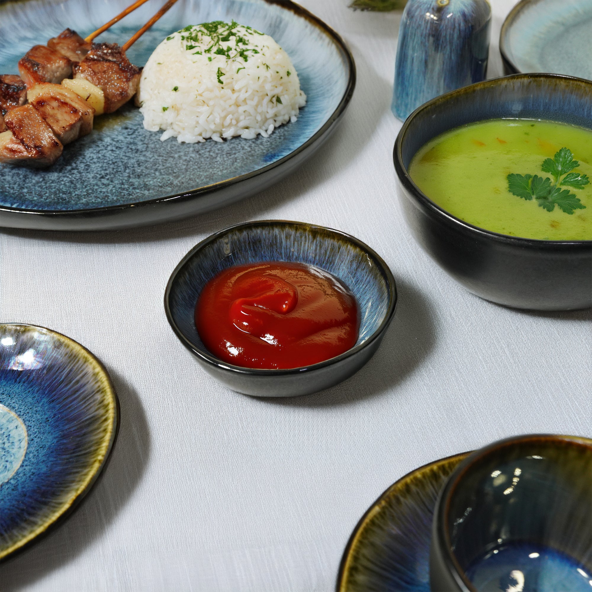 Set of BEACON Blue Wave Soil Black and Blue plates with wave design, suitable for dining and special occasions.