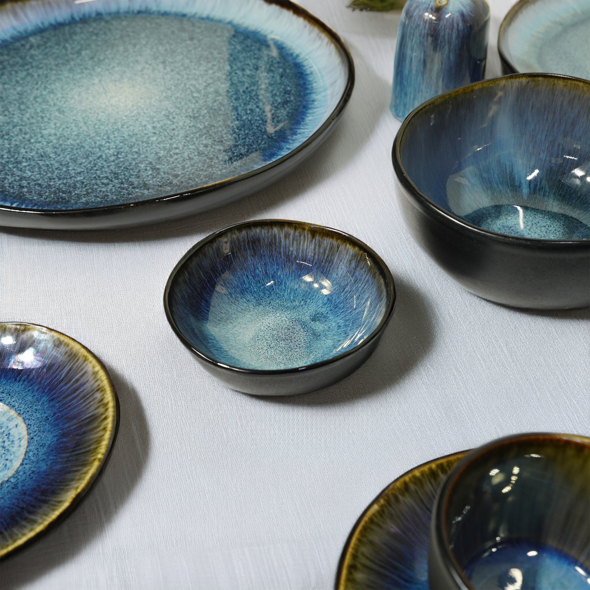 Blue Wave Soil Black and Blue Plates by BEACON, featuring a vibrant blue wave design on durable dinnerware.