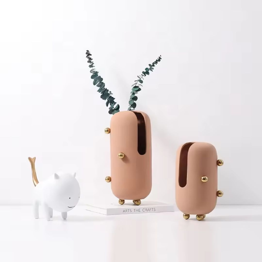 Small blush ceramic vase with gold stainless steel detail, featuring a sleek, modern design perfect for stylish home decor.