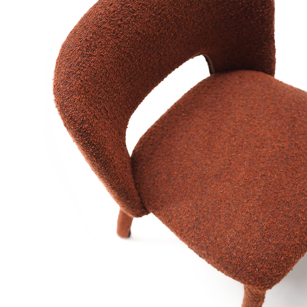 Brown dining chair with steel frame and cushioned seat, designed for modern dining rooms by BEACON.