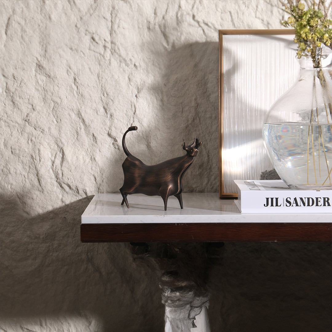Beige bull sculpture from BEACON home decor figurines collection, detailed metal art for stylish interior decoration.