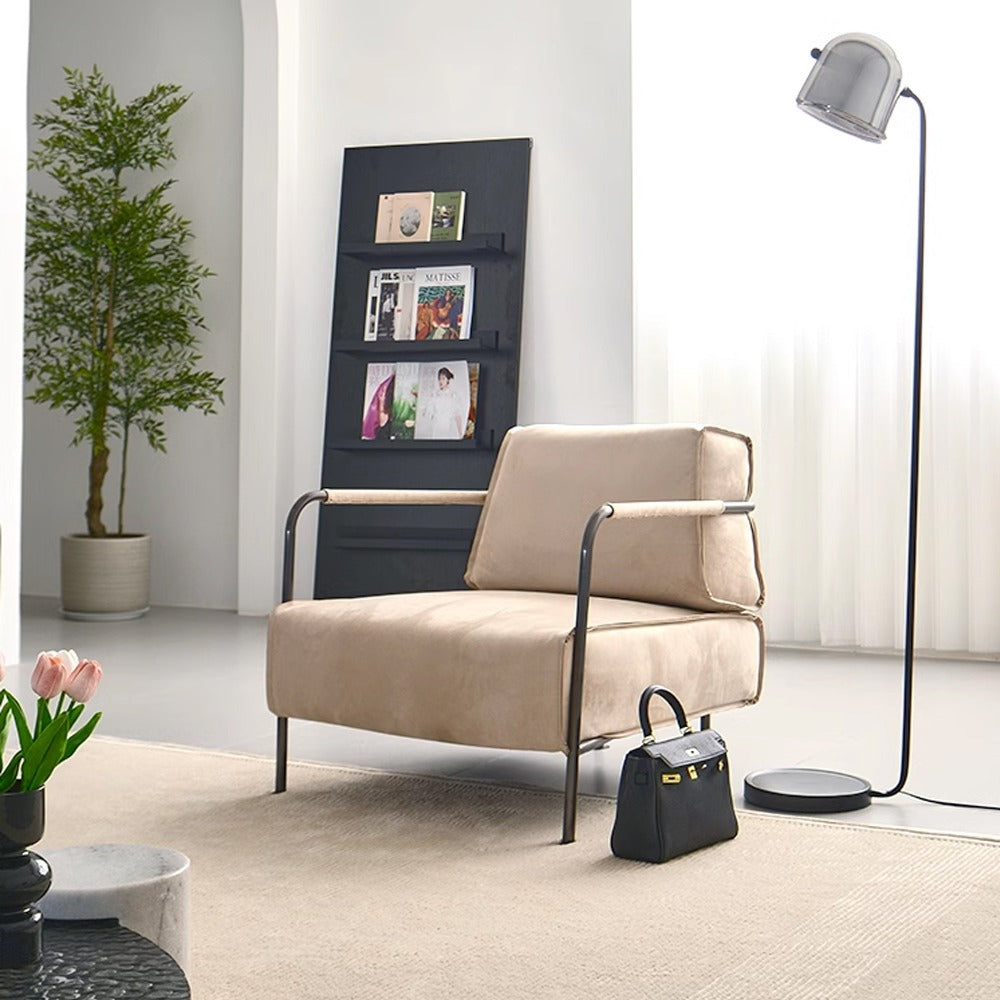 Beige Caesar lounge chair with black iron rack frame by BEACON, modern armchair for stylish seating and relaxation.