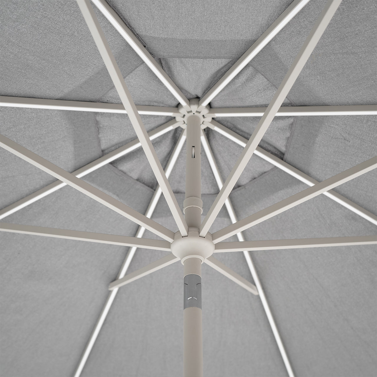 BEACON celestial center pole outdoor umbrella with crank and wheeled base, featuring a large canopy for shade.