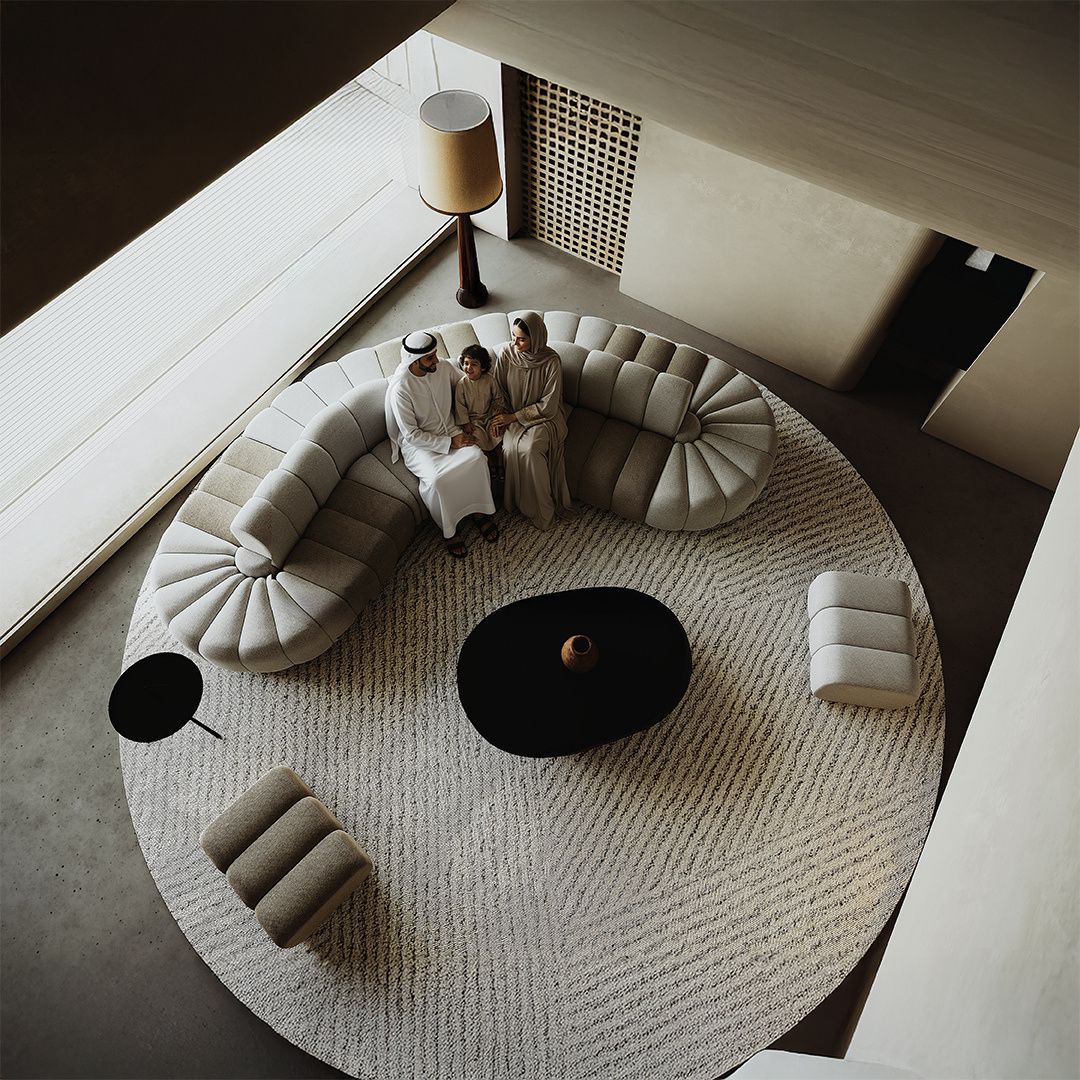 BEACON Chameleon Sofa Curved Pouf Ottoman with soft fabric and modern design, perfect as versatile seating or a footrest.