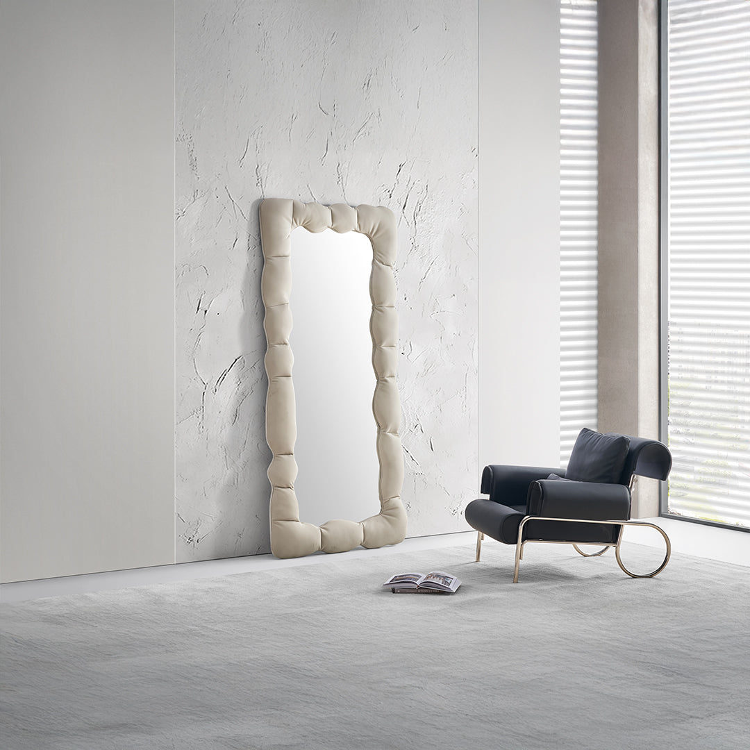 BEACON CloudPuff upholstered full-length mirror with padded frame, standing upright in a modern bedroom setting.
