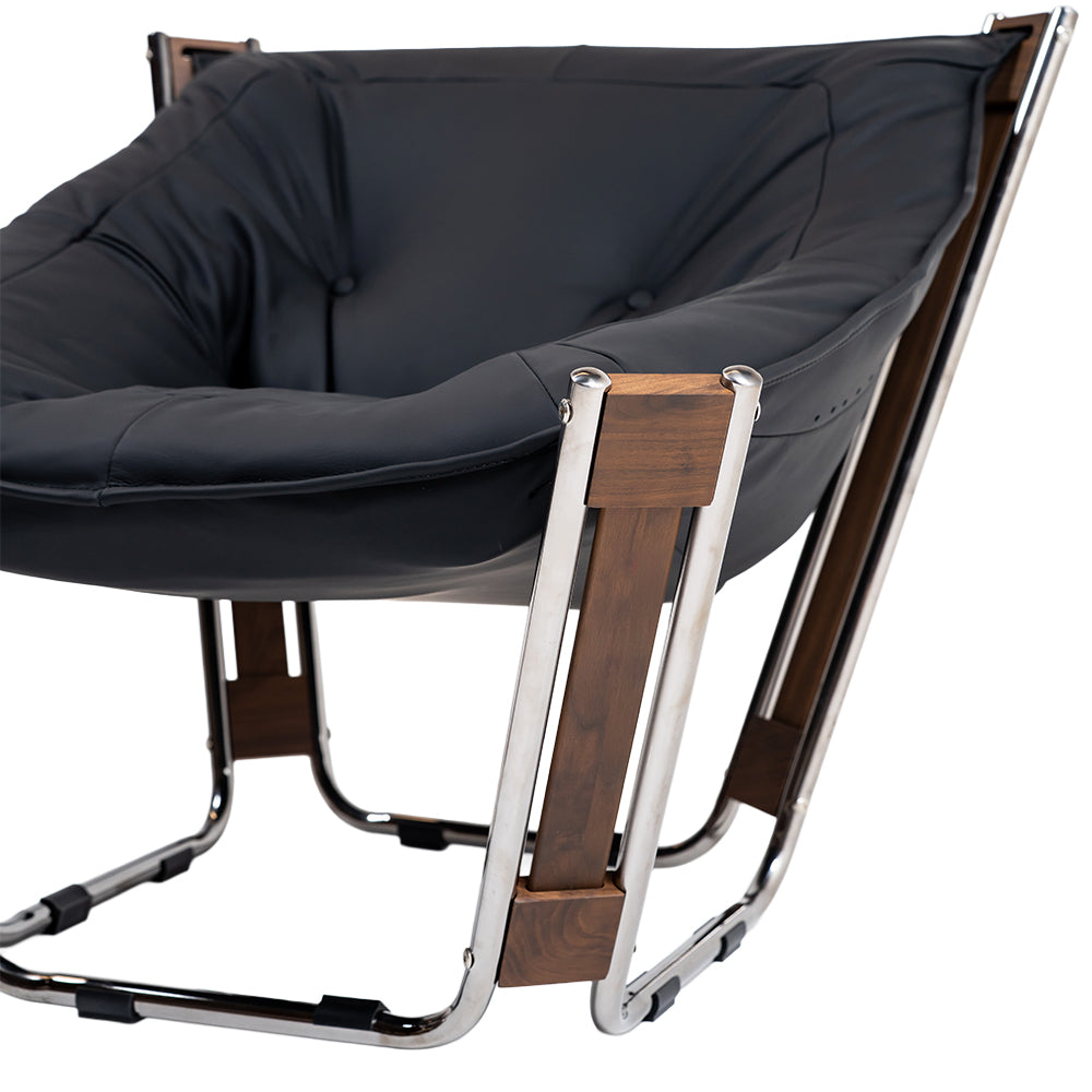Black Cocoon Lounge Chair by BEACON, modern and cozy with a rounded design, perfect for relaxing living spaces.