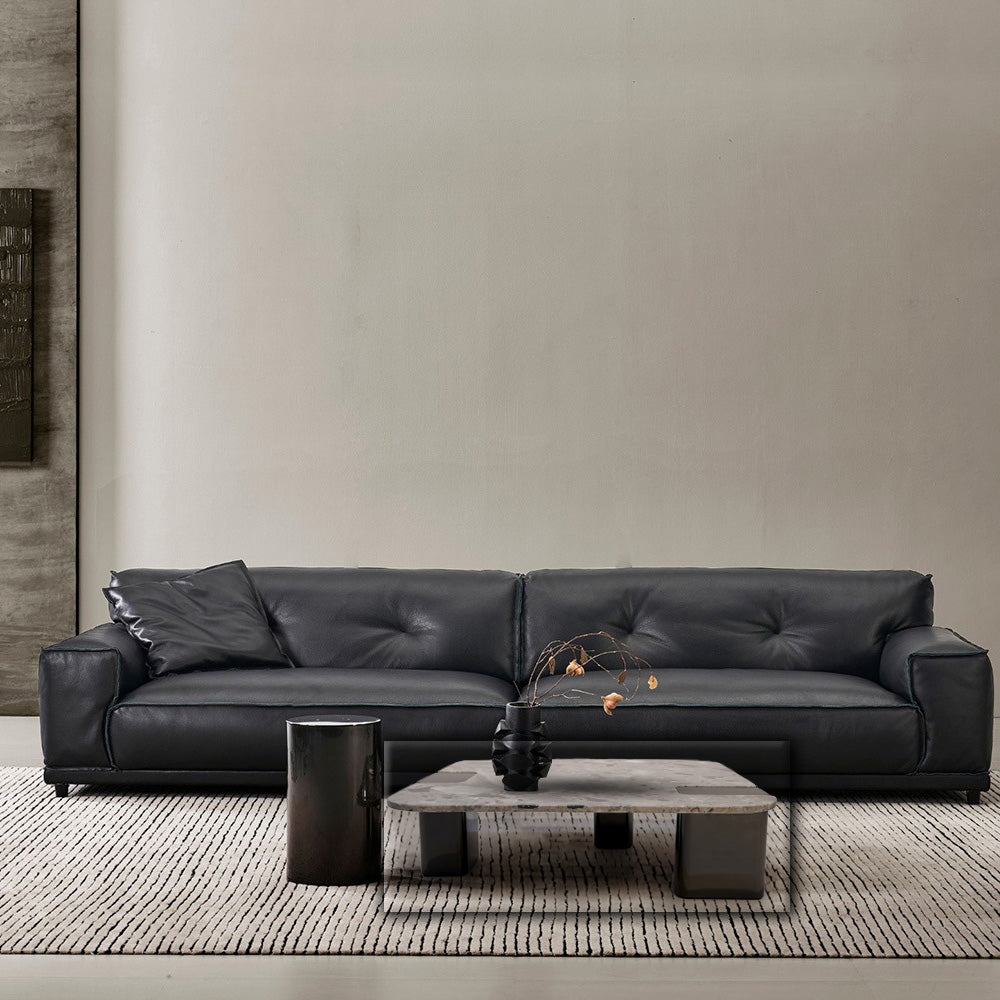 Elegant coffee table with a natural stone top and stainless steel legs, designed by BEACON for modern living spaces.