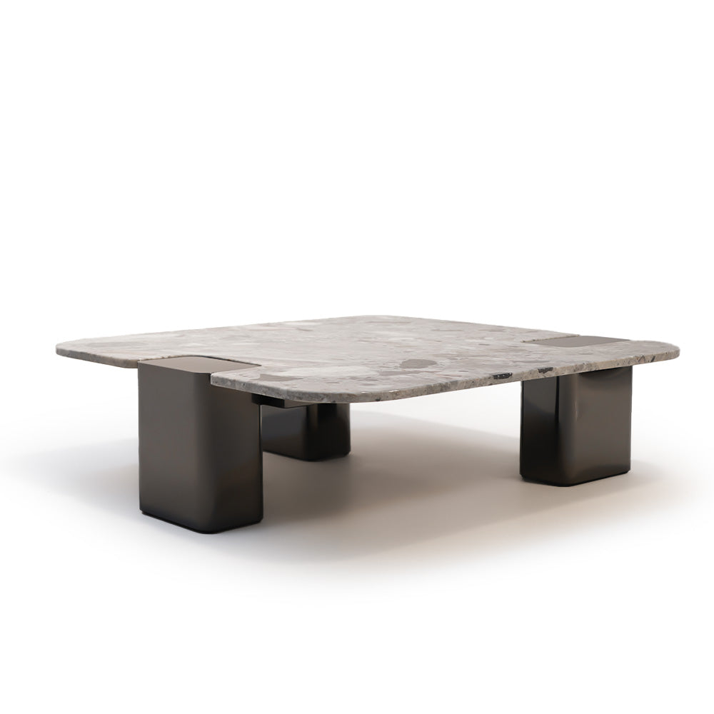Modern coffee table with a natural stone top and sleek stainless steel legs, designed by BEACON.