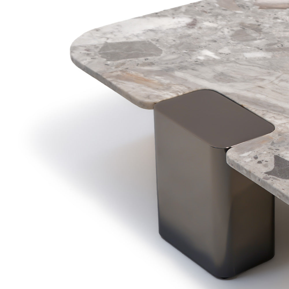 Modern coffee table with a natural stone top and stainless steel legs, designed by BEACON for stylish living room decor.