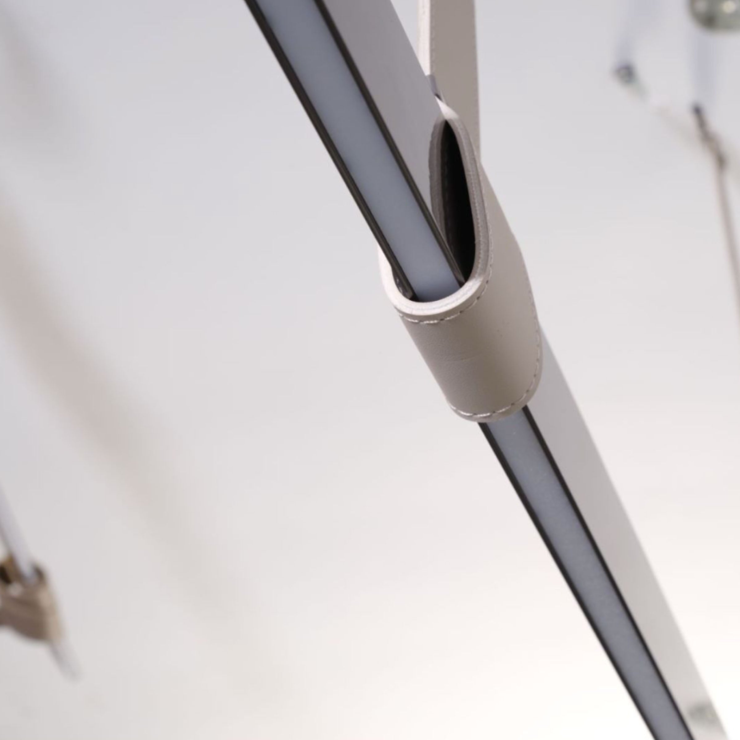 Black leather pendant lamp with comet tail design, 1.5m length, by BEACON, hanging with a sleek modern style.