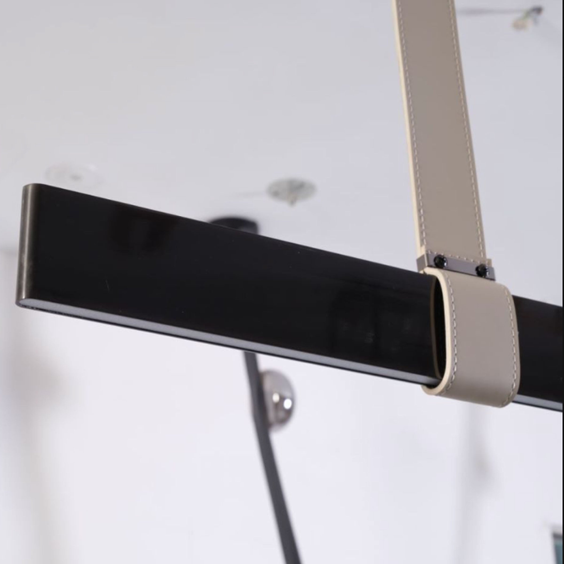 Black leather pendant lamp with comet tail design, 1.5m length, by BEACON, featuring a sleek, modern look for contemporary interiors.
