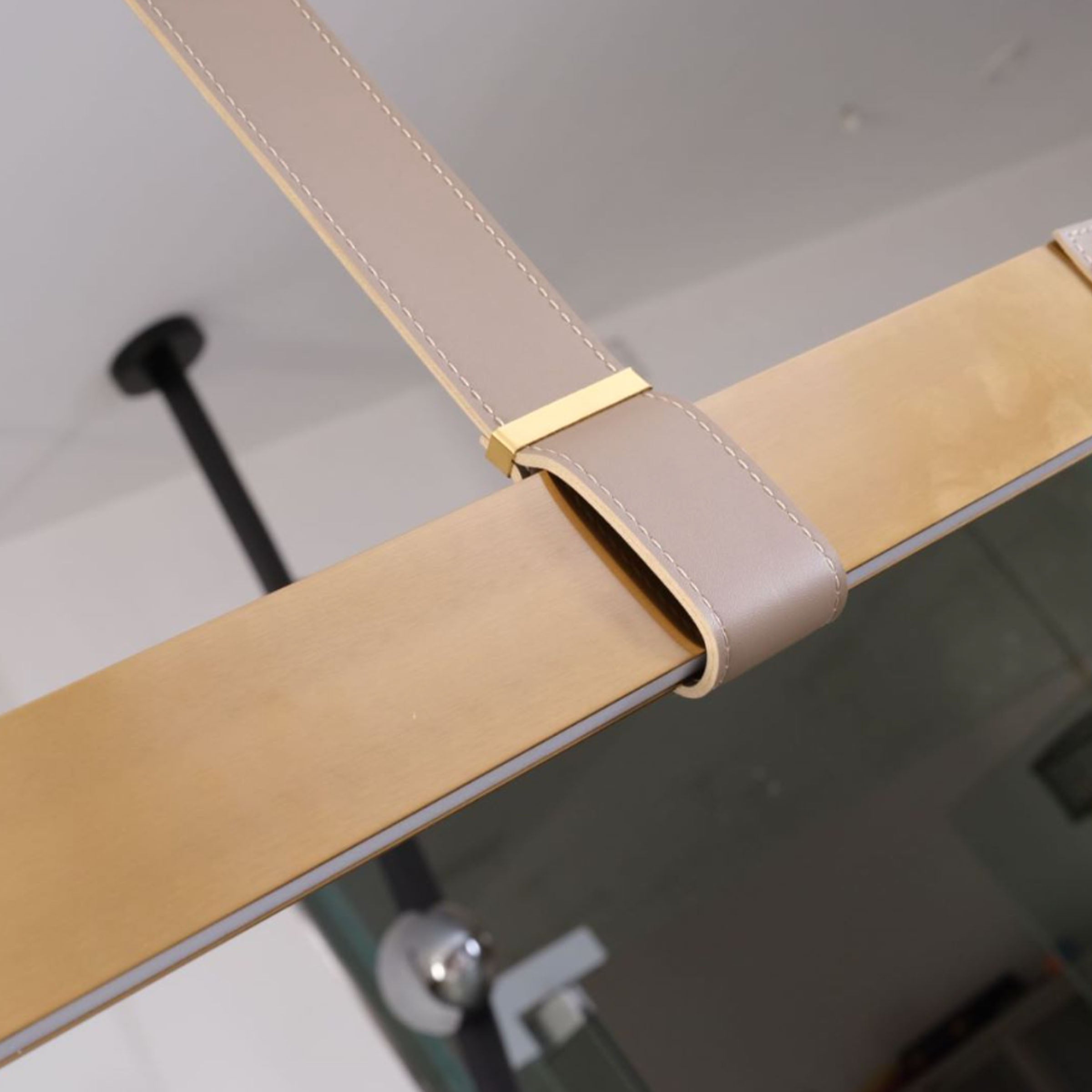 Gold leather pendant lamp with comet tail design by BEACON, 1.5m length, modern lighting fixture for stylish interiors.