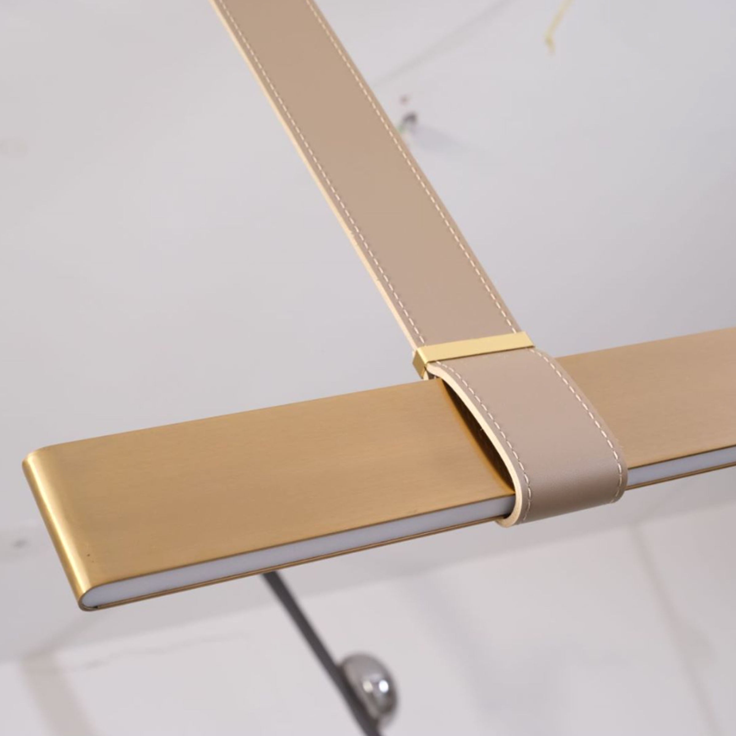 Gold leather pendant lamp with comet-tail design from BEACON, 1.5m length, modern lighting fixture for stylish interiors.