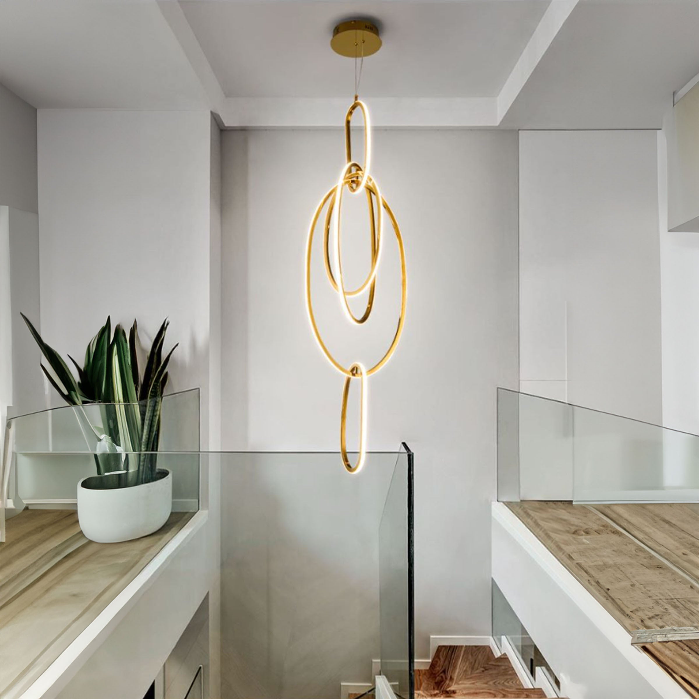 Golden Cosmic Rings pendant lamp by BEACON, modern pendant lighting fixture with a celestial-inspired ring design.